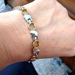 - - 2 toned tennis bracelet. Silver and Gold toned. 8 inches. Hearts.…